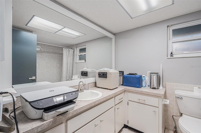 bathroom with toilet, tile walls, walk in shower, and vanity