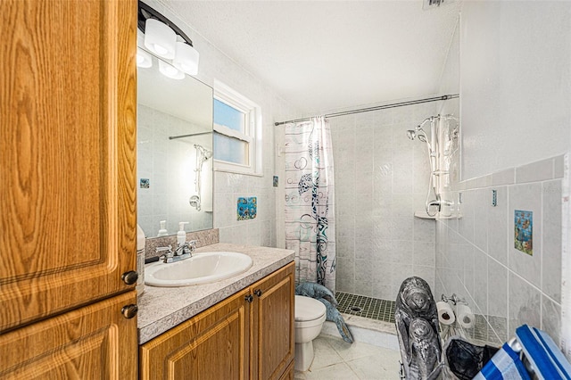 bathroom with toilet, a shower with shower curtain, tile patterned flooring, and tile walls