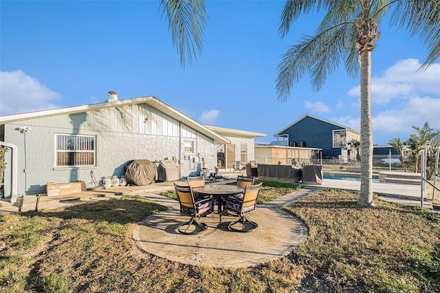 back of house with a patio and a swimming pool