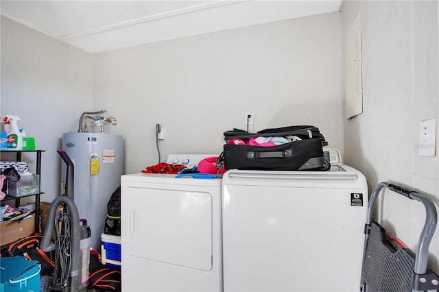 laundry room with electric water heater and independent washer and dryer