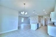 kitchen featuring decorative light fixtures and white cabinetry