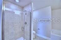 bathroom with a shower with shower door