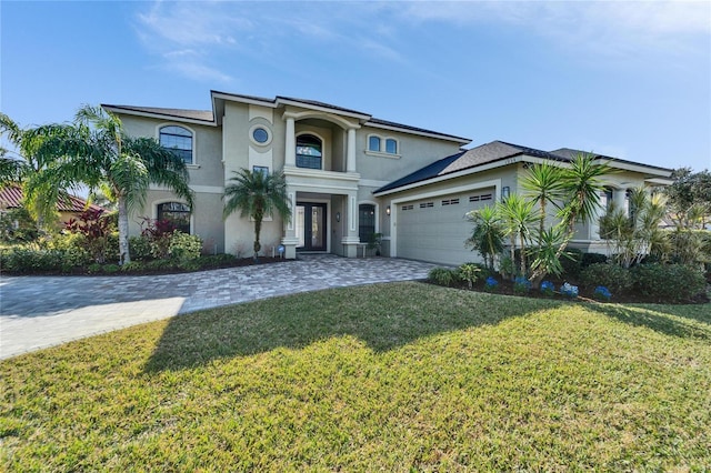 view of front of house featuring a garage and a front lawn