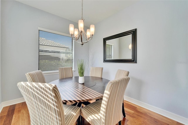 dining room with an inviting chandelier and light wood-type flooring