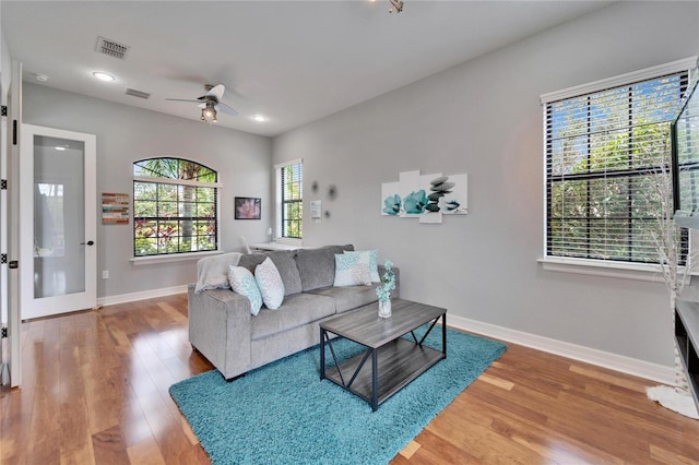 living room featuring ceiling fan and hardwood / wood-style floors