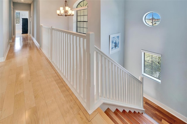 hall with a chandelier and light hardwood / wood-style flooring