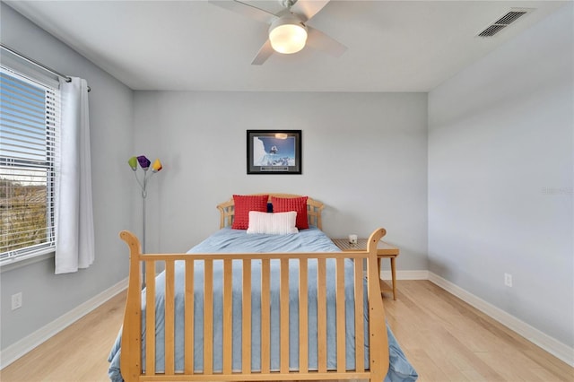 bedroom with ceiling fan and light wood-type flooring