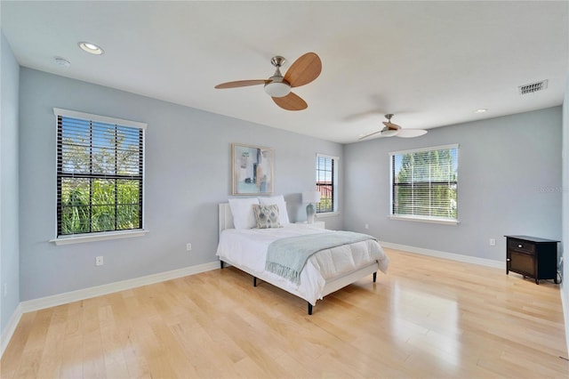 bedroom with light hardwood / wood-style floors and ceiling fan