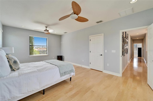 bedroom with ceiling fan and light wood-type flooring