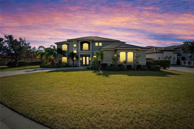 view of front of house with a yard and french doors