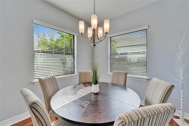 dining room featuring an inviting chandelier and wood-type flooring