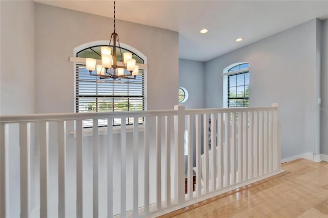 hallway with an inviting chandelier