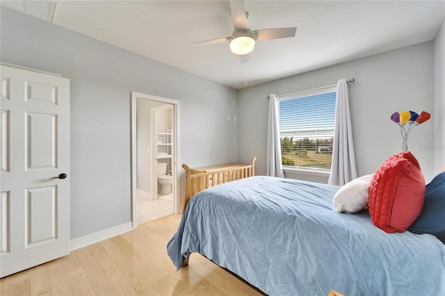 bedroom with connected bathroom, ceiling fan, and light hardwood / wood-style flooring