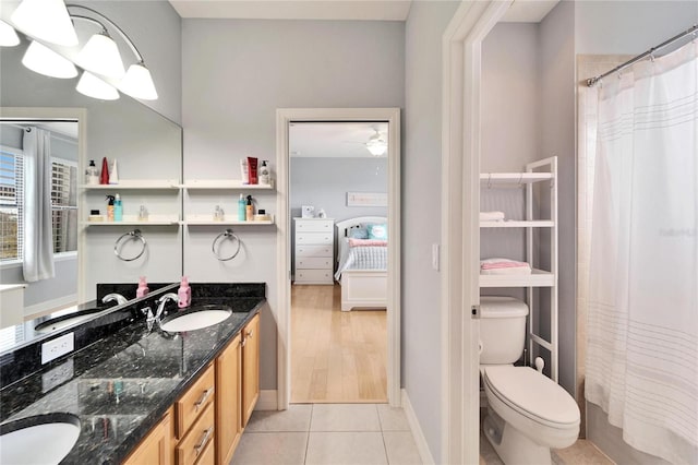 bathroom featuring vanity, tile patterned floors, and toilet