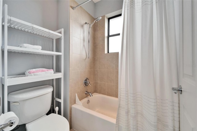 bathroom with shower / bath combo and toilet