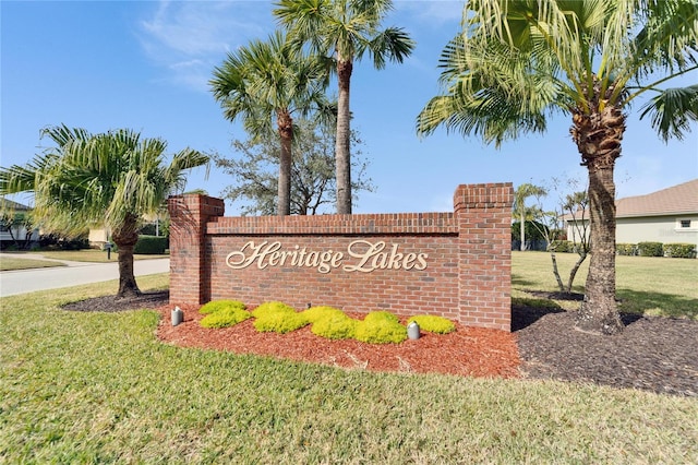 community / neighborhood sign with a lawn