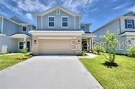 view of front of property featuring a front lawn and a garage