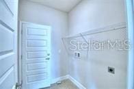 clothes washing area featuring electric dryer hookup