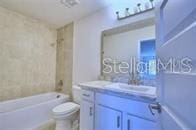 full bathroom with toilet, shower / bath combination, and vanity