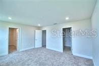 unfurnished bedroom featuring dark carpet