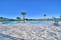 view of swimming pool with a water view and a view of the beach