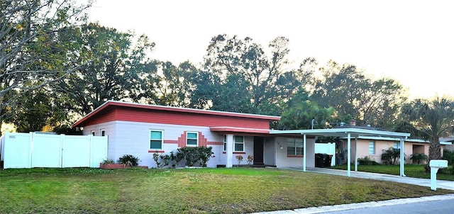 view of front of home with a front yard and a carport