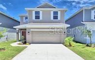 front of property with a front yard and a garage