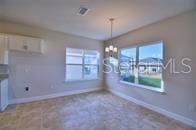 unfurnished dining area with a notable chandelier