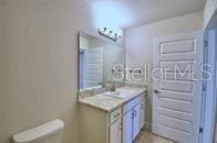 bathroom featuring vanity and toilet