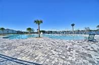 view of swimming pool featuring a water view and a view of the beach