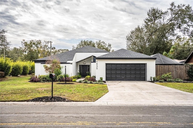 view of front of home featuring a front lawn and a garage