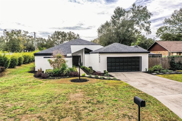 view of front of property featuring a garage and a front lawn