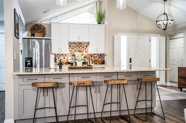 kitchen with gray cabinets, white cabinetry, stainless steel fridge with ice dispenser, and vaulted ceiling