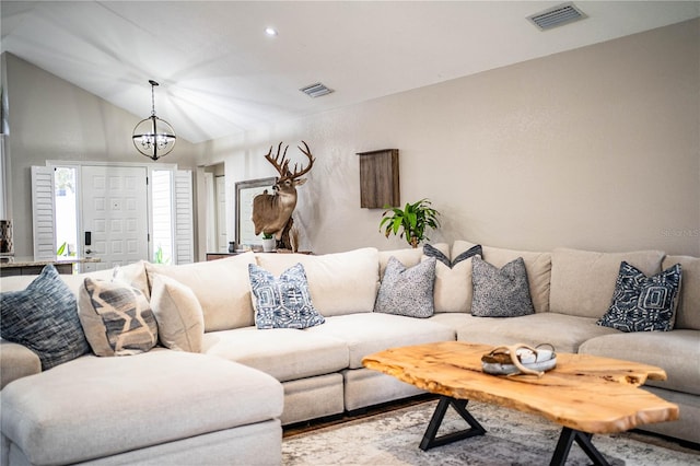 living room featuring lofted ceiling and a chandelier