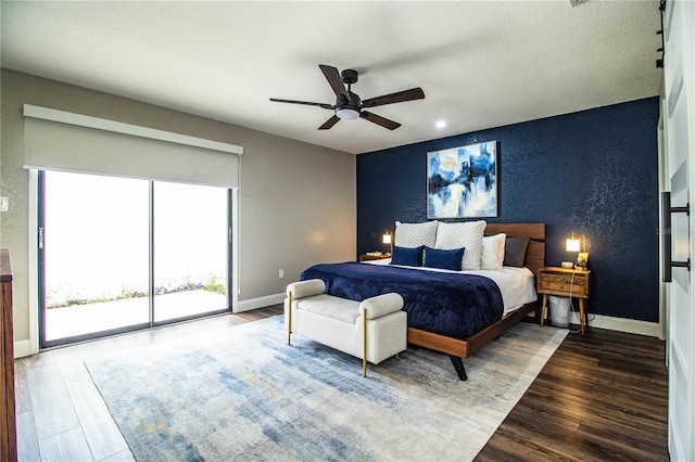 bedroom featuring ceiling fan, access to exterior, and hardwood / wood-style flooring