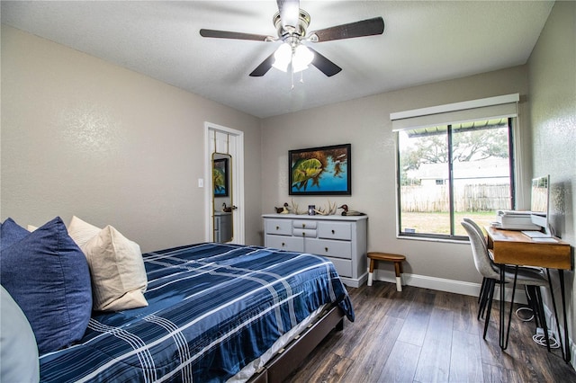 bedroom featuring ceiling fan, a textured ceiling, and dark hardwood / wood-style flooring