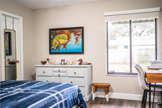 bedroom featuring dark wood-type flooring and multiple windows