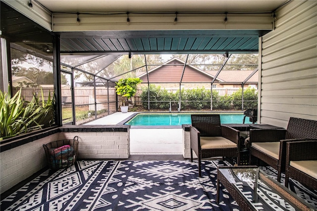 view of pool with glass enclosure and a patio