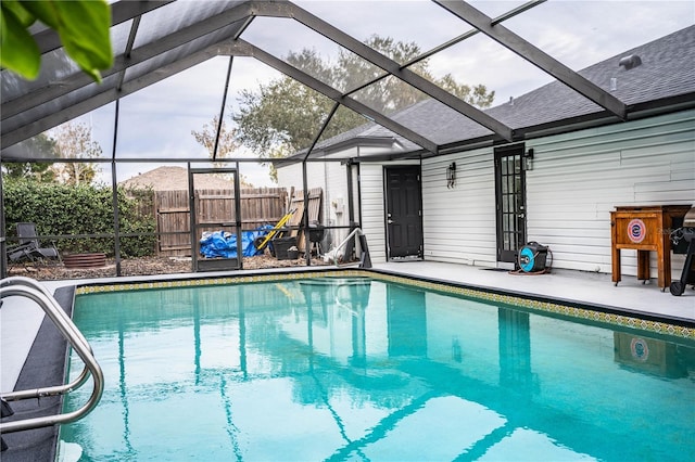 view of swimming pool with a lanai and a patio