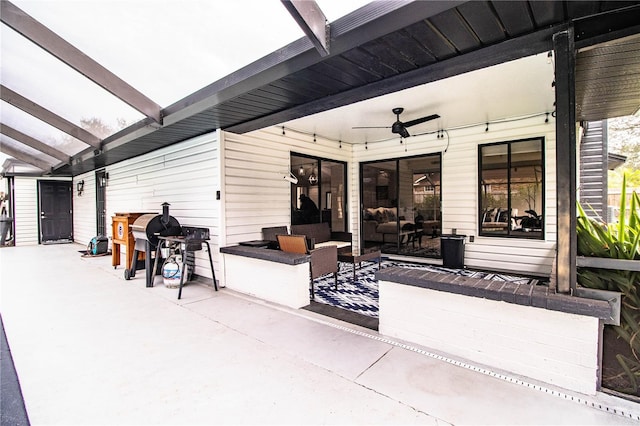 view of patio / terrace with ceiling fan and a pergola