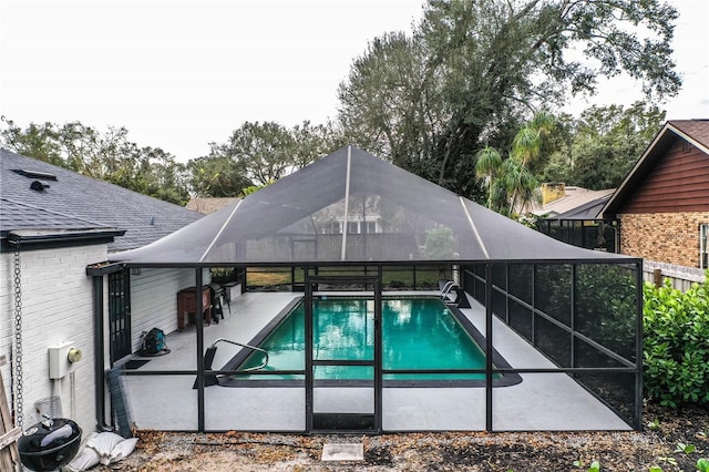 view of swimming pool with a lanai and a patio area