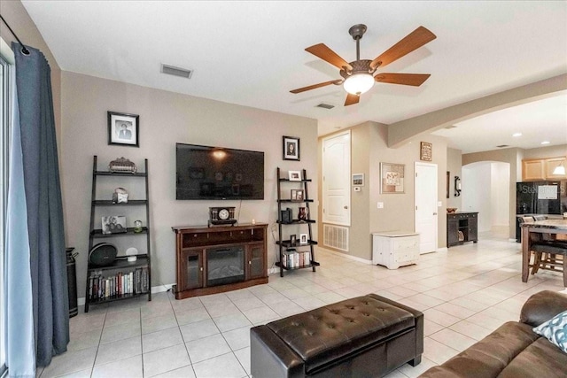 living room with ceiling fan and light tile patterned floors