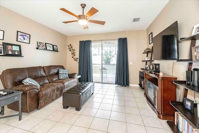 tiled living room with ceiling fan