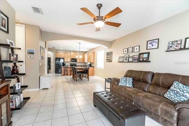 tiled living room with ceiling fan