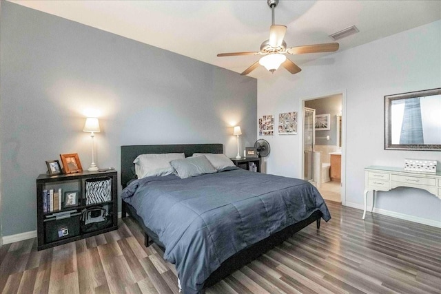 bedroom with dark wood-type flooring, ceiling fan, lofted ceiling, and ensuite bath