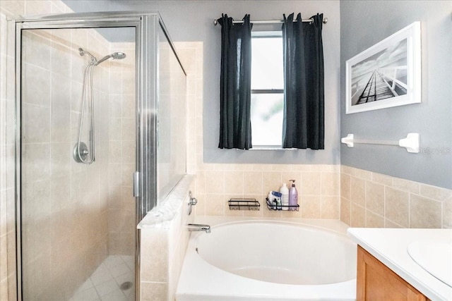 bathroom featuring a wealth of natural light, vanity, and independent shower and bath