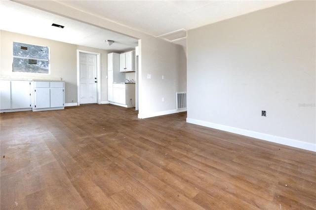 unfurnished living room featuring hardwood / wood-style flooring