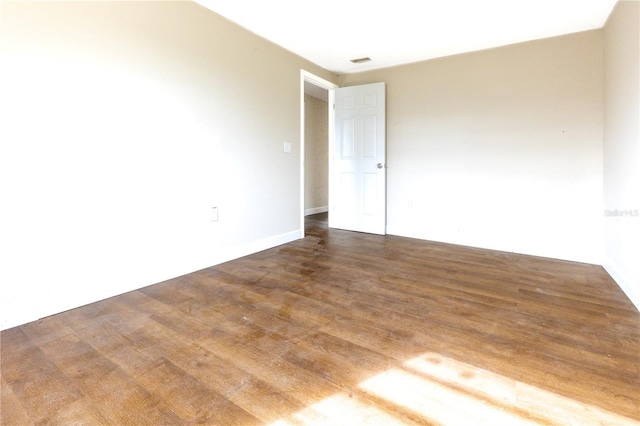 spare room with dark wood-type flooring