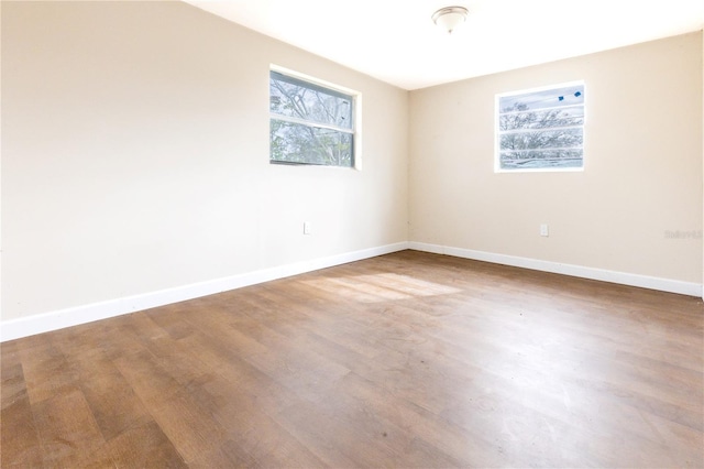 empty room with hardwood / wood-style flooring