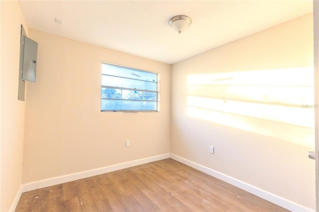 empty room featuring wood-type flooring and vaulted ceiling